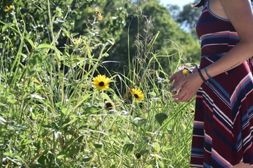young woman picking flowers