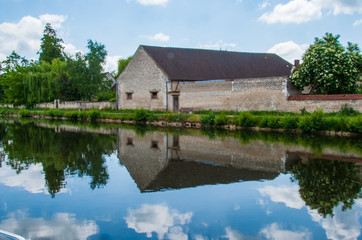 Obraz premium Reflection of Building in French Canal