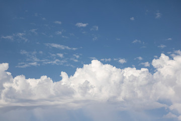 Fluffy white clouds on a blue sky.