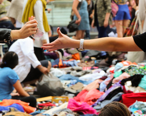 Money changing hands at a suitcase rummage, or clothing swap