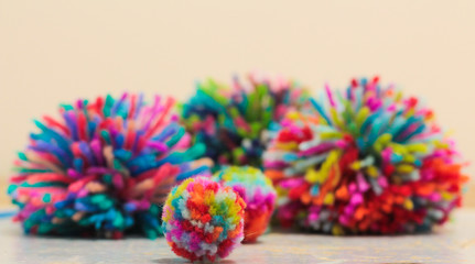 Group of colourful hand made wool pom poms