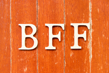 Alphabet letter in word  BFF (Abbreviation of best friend forever) on old red color wood plate background