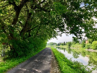 Fototapeta na wymiar Summer landscape - bike path along the canal Richelieu, Quebec, Canada