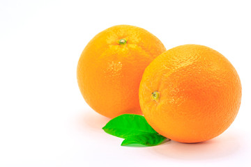 Fresh orange fruit with leaf on white background
