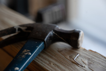 Damaged wood and bent nail from being hit at an angle