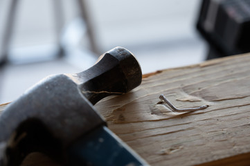 Damaged wood and bent nail from being hit at an angle