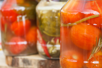 Fototapeta na wymiar Marinated tomatoes in glass jar. Healthy snack