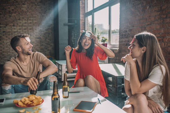 Group of friends playing a game with sticky notes