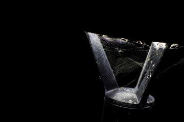 Street lamp with cobweb in the darkness. Scary Halloween concept with black background and empty space on the side.