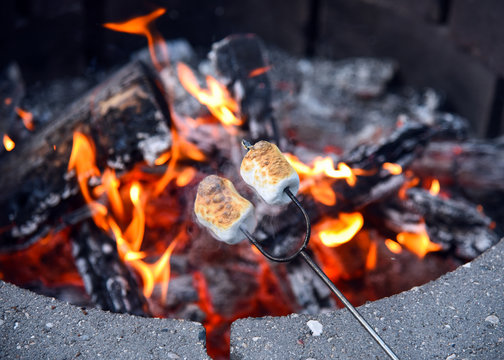 Roasting marshmallows over hot fire