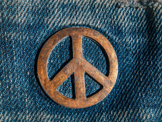 Iron sign of a pacifist on denim. The symbol of the struggle for peace. Ideology. Place for your...