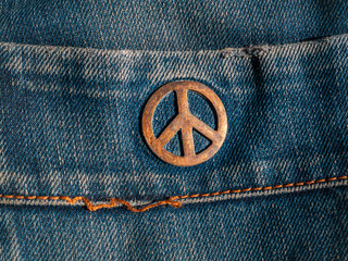 Iron sign of a pacifist on denim. The symbol of the struggle for peace. Ideology. Place for your...