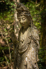 Obraz premium Buddhist sculpture in the Okunoin cemetery in Koyasan Mount Koya, UNESCO world heritage site and a 1200 years old center of Japanese sect of of Shingon Buddhism in Wakayama Japan