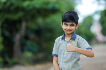 indian school boy showing thumb up