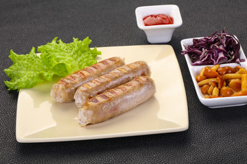 Grilled sausages served mushrooms and cabbage