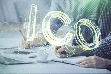 Blockchain theme hologram with man working on computer on background. Concept of crypto chain....