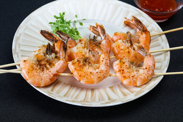 Grilled prawn skewer with sauce