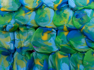 Blue and green plasticine scale background. Close up texture.