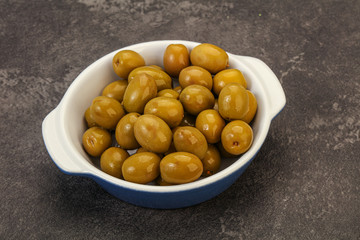 Green pickled olives in the bowl