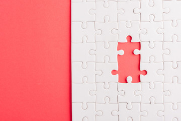 Top view flat lay of paper plain white jigsaw puzzle game texture incomplete or missing piece,...