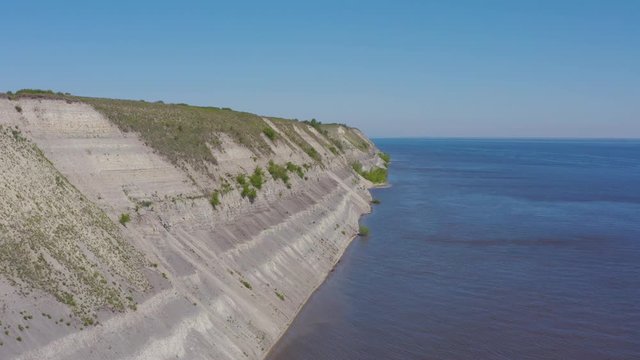 Steep bank of the river from a bird's eye view. Bank of the Volga River in Russia. Aero 4k