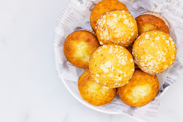 Freshly baked tasty vanilla muffins and muffins with crumble topping. Light background.