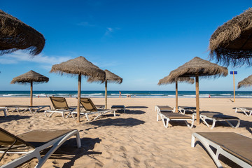 Parasols and hammocks on La Barrosa beach in Sancti Petri, Cadiz, Spain