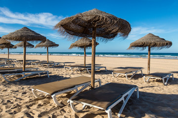 Parasols and hammocks on La Barrosa beach in Sancti Petri, Cadiz, Spain