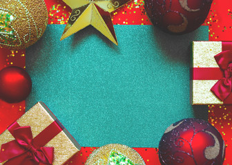 gift boxes with bows and Christmas toys on a red-green background