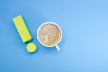 Exclamation mark and a cup of coffee on blue background 