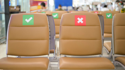 Social distancing chairs in International Airport, Coronavirus prevention concept