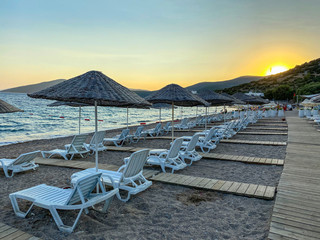 empty beach and sunbeds in the evening