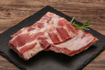 Raw pork ribs served rosemary