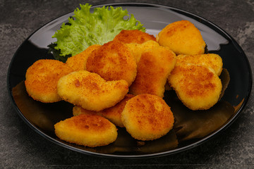 Fried chicken nuggets served salad leaves