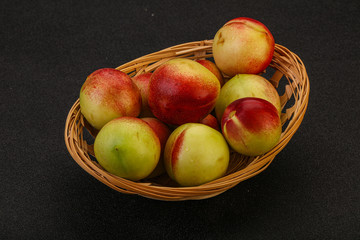 Sweet small nectarines in the basket