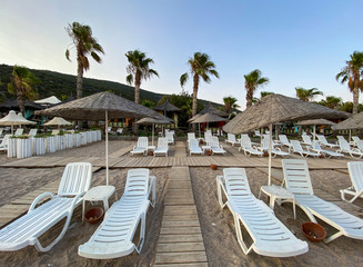 empty beach and sunbeds in the evening
