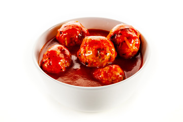 Roast meatballs with sauce on white background
