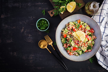 Tabbouleh salad. Traditional middle eastern or arab dish. Levantine vegetarian salad with parsley, mint, bulgur, tomato. Top view