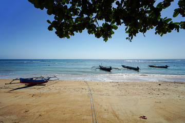 Timor Leste beach near Baucau with traditional wooden catamaran style boats