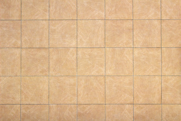 Fototapeta premium Photo of a wall covered with khaki tiles as background material
