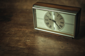 Mechanical clock in the style of the 70s and 80s on a wooden table