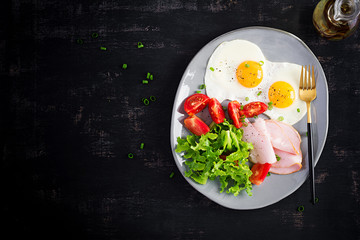 Ketogenic/paleo diet. Fried eggs, ham and fresh salad.  Keto breakfast. Brunch.  Top view, overhead