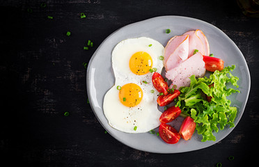 Ketogenic/paleo diet. Fried eggs, ham and fresh salad.  Keto breakfast. Brunch.  Top view, overhead