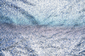 Obraz premium Shiny fabric texture. Silver sparkling background. Clothing piece of glitter metallic for a glamorous party, celebration. Close-up.