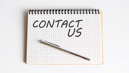 Text on notepad CONTACT US . Business Concept