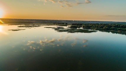 aerial shot of morning clouds reflected in lake beleu, moldova