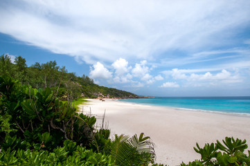 Summer scenic view of Anse Cocos sandy beach in a beautiful tropical bay. La Digue Island, Seychelles