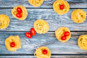 Nests of tagliatelle noodles with mini tomatoes