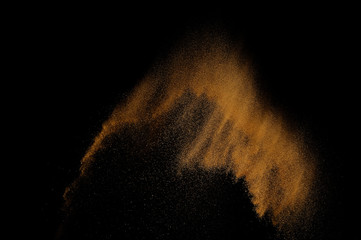 Sandy explosion isolated on black background. Abstract sand cloud.
