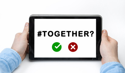 Male hands holding tablet pc with text TOGETHER on white background